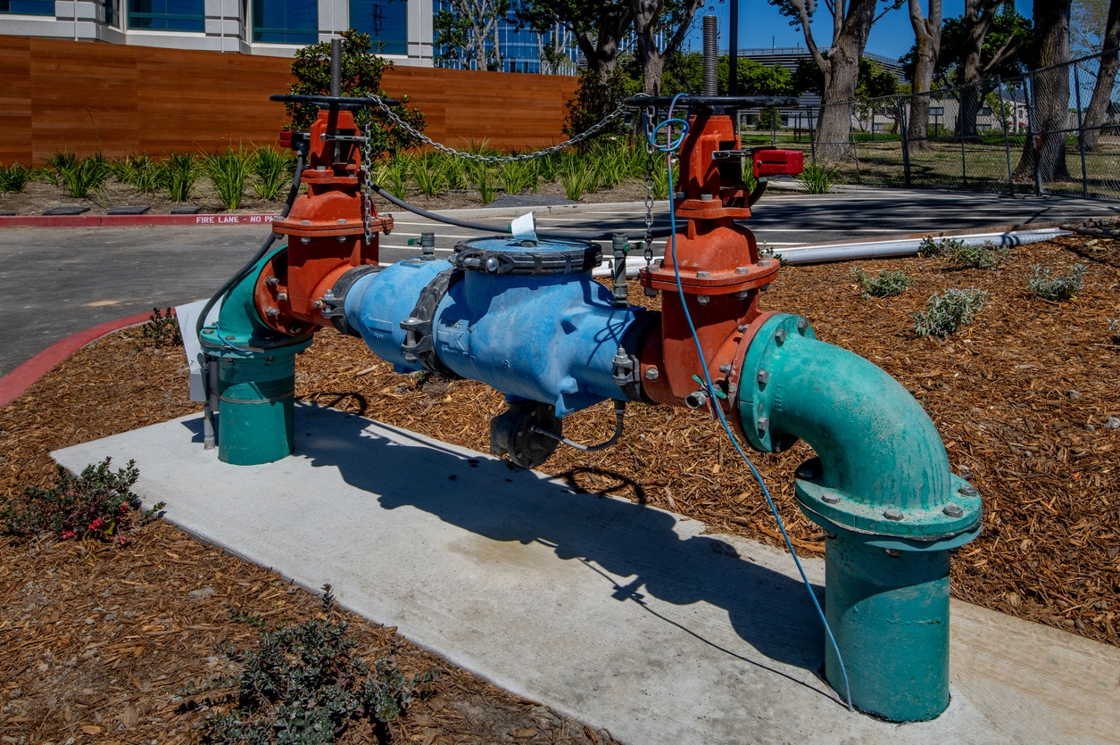 a blue fire hydrant sitting on the side of a building